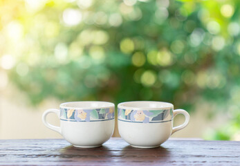 Coffee cups on wooden table and copy space text.