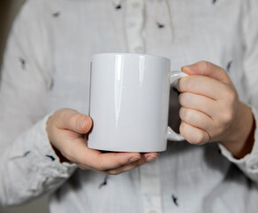 Girl holding blank white coffee mug , white porcelain mug mock up, coffee, tea, milk or soda, copy space