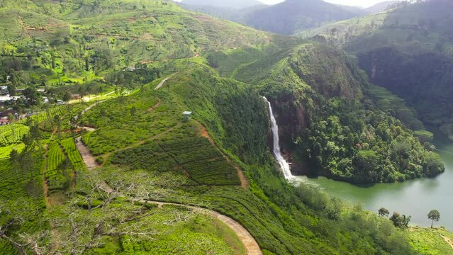 Gartmore waterfall falling into the lake among tea plantations. Maskeliya, Sri Lanka.