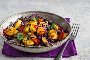 Multicolor delicious salad with shrimp in a stylish dish on a purple napkin