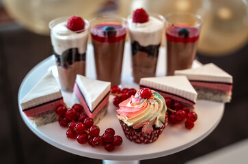 Candy bar sweets with berries and cream