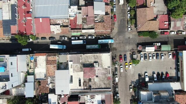 a top view of the streets where you can see trucks, cars and people