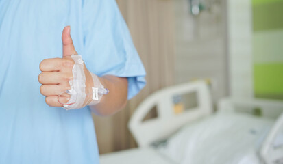 patience man hand raised thumb up fro praised about insurance and therapy in  room at hospital for health lifestyle concept