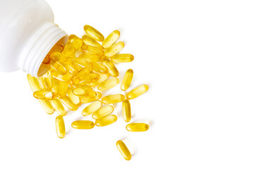 Pile of softgels capsules Omega 3 in bottle isolated on white background. Close up, top view, flat lay with copy space