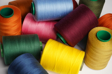 Colorful thread spool background, close-up
