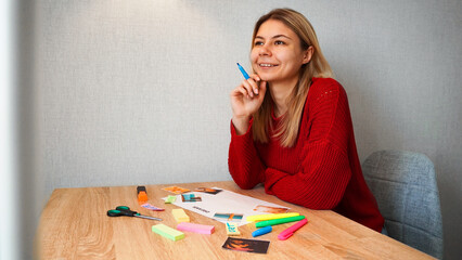 Young woman creating Feng Shui wish map using inscriptions and photos. All photos are taken by the...