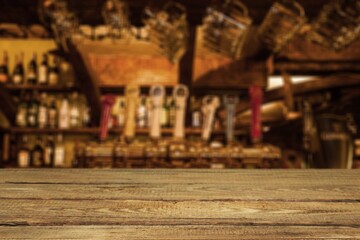 Wooden board and beautiful shelves with alcohol bottles at the background. Bar concept.