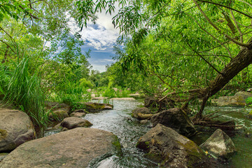 park outdoor landscape river stream with rocks and green foliage springtime environment