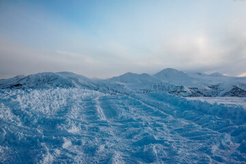 Snowy road with mountain landscape