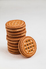 A stack of sandwich cookies close up with chocolate filling on a white background.