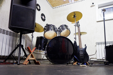 musical instruments - drums and electric guitar are in the corner in the garage