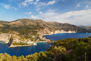 Fototapeta na wymiar Fantastic top view at Asos village, Assos peninsula and blue Ionian Sea water. Aerial view, summer scenery of famous and extremely popular travel destination in Cephalonia, Greece, Europe