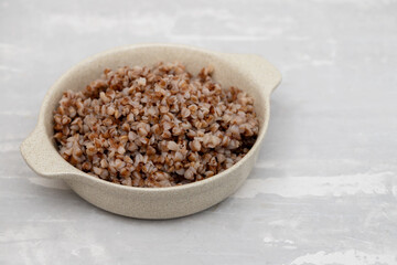 boiled buckwheat in small white bowl on ceramic