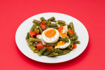 salad green beans, pepper and boiled eggs on plate