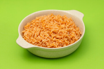 tomato rice on the dish on green background