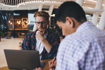 Multiracial business men working in office space