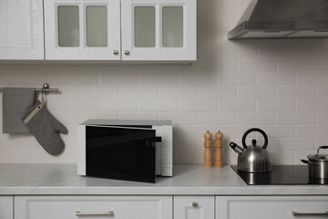 Modern microwave oven on countertop in kitchen