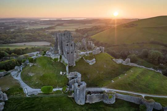 Aerial view of the abandoned ruins of Corfe Castle at sunrise, Dorset, England