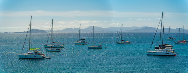 View of watersport, sailboats and Fuerteventura in background, Playa Blanca, Lanzarote, Canary Islands