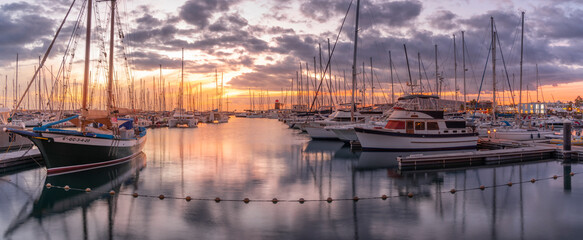 View of boats and Marina Rubicon Shopping Center in Rubicon Marina at sunset, Playa Blanca, Lanzarote, Canary Islands
