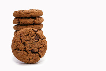 Chocolate chip cookies are stacked on a white background. Delicious homemade cookies with free space for text and advertising. Great dessert for milk or coffee. american breakfast