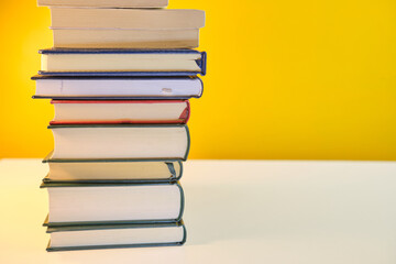 Collection of Book stack in the library room on yellow background