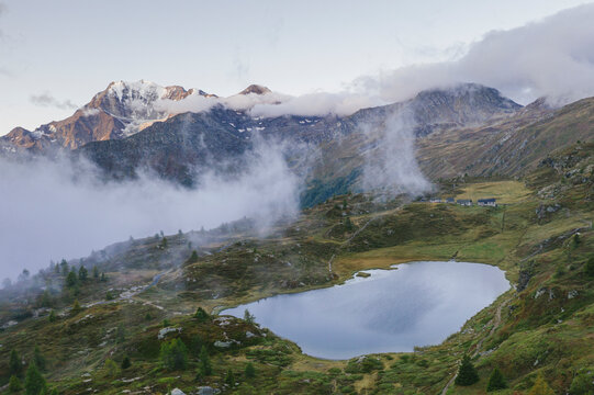 Aerial view of Hopschusee lake with Fletschhorn and Galehorn peaks in mist at sunrise, Simplon Pass, Valais canton, Swiss Alps, Switzerland