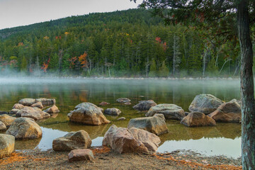 Fototapeta na wymiar morning fog and mist on the shores of Jordon's Pond in Acadia national Park in Autumn 
