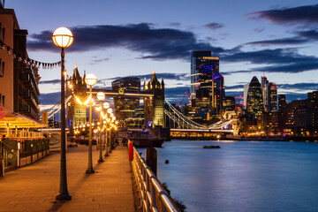 Tower Bridge and The City at sunset from Shad Thames, London, England