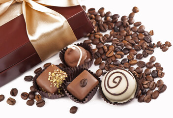brown box with candies and golden tape, coffee grains