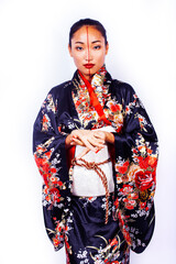 young pretty geisha in black kimono posing isolated on white background, asian ethno