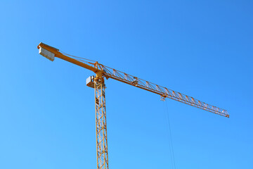 Construction crane on a new construction site of high-rise building