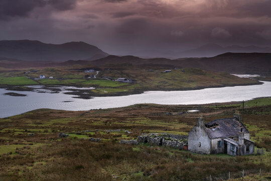 Abandoned Croft backed by Loch Eireasort and the Harris Hills, near Baile Ailein, Isle of Lewis, Outer Hebrides, Scotland
