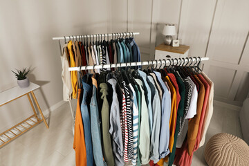 Racks with stylish clothes indoors, above view. Fast fashion