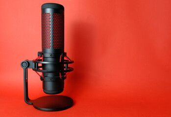 
Microphone for podcasts and sound recording. Stands on a red background. Studio condenser...