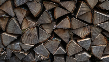 Stacks of firewood. Preparation of firewood for the winter. Natural background. Wall, Background of dry chopped firewood logs.