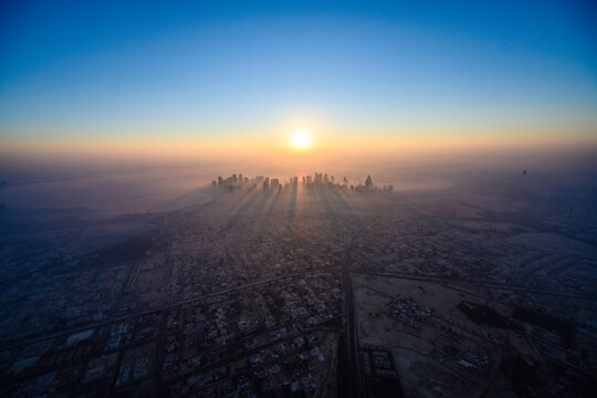 Doha skyline at sunrise with morning fog