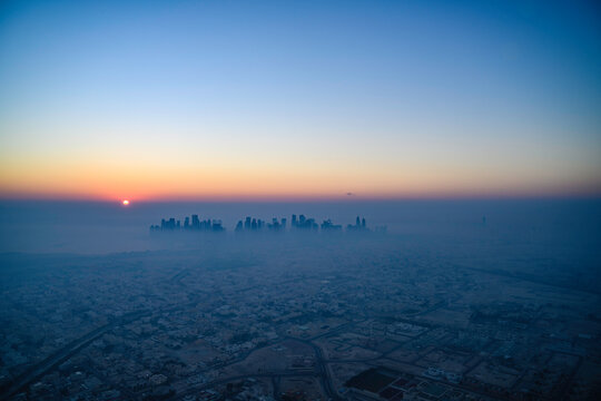 Doha skyline at sunrise with morning fog