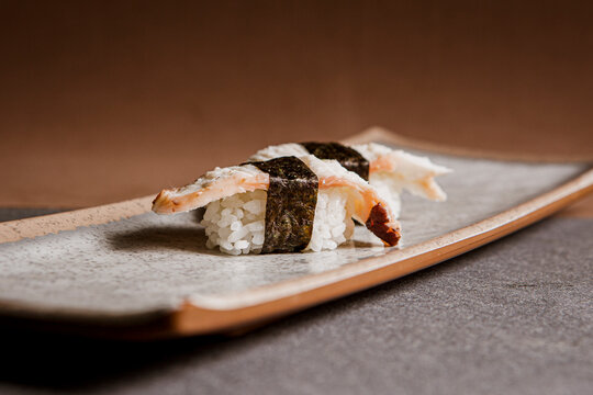 Tako nigiri sushi or octopus sushi isolated on a tradicional ceramic plate background, Japanese food. Copy space.