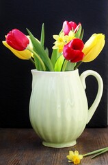 spring flowers in a vase, tulips, daffodils