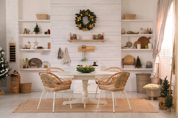 Cozy dining room interior with Christmas tree and festive decor