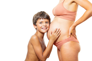 Child hands touch pregnant belly: expect a sister