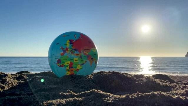 earth ball on the beach- travel or future concept