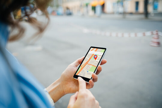 Woman tourist use maps app to navigate city