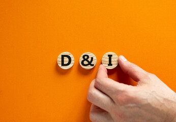Fototapeta na wymiar D and I, Diversity and inclusion symbol. Concept words D and I, diversity and inclusion on wooden circles on beautiful orange background. Business, D and I, diversity and inclusion concept.