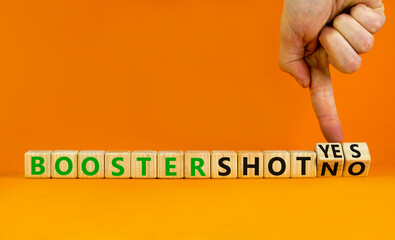 Covid-19 booster vaccine shot yes or no symbol. Doctor turns cubes and changes words booster shot no to booster shot yes. Beautiful orange background copy space. Covid-19 booster vaccine shot concept.