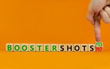 Covid-19 booster vaccine shots yes or no symbol. Doctor turns cubes changes words booster shots no to booster shots yes. Beautiful orange background copy space. Covid-19 booster vaccine shot concept.