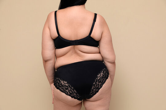 Studio shot of happy mature woman with fit body in black underwear