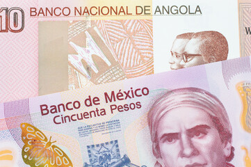 A macro image of a pink, plastic fifty peso bank note from Mexico paired up with a colorful ten kwanza bank note from Angola.  Shot close up in macro.