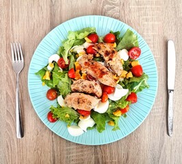 Classic Caesar salad with tomato, chicken and egg